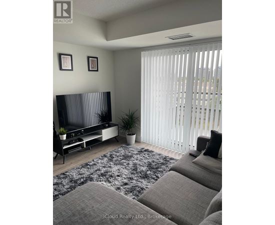 A living room with a grey sofa and a television.