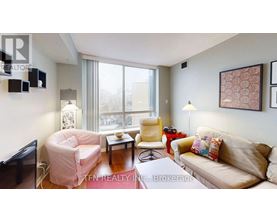 A living room with a couch, chair, and television.