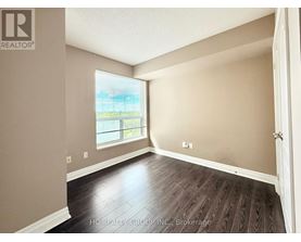 A room with a window and wooden flooring.