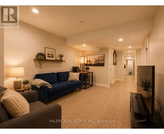 A living room with a blue couch and a television.