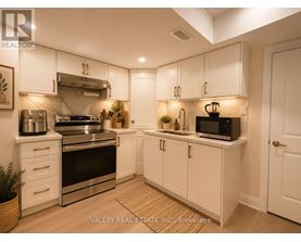 A kitchen with white cabinets and stainless steel appliances.