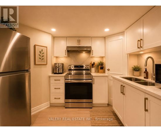 A modern kitchen with white cabinets and stainless steel appliances.