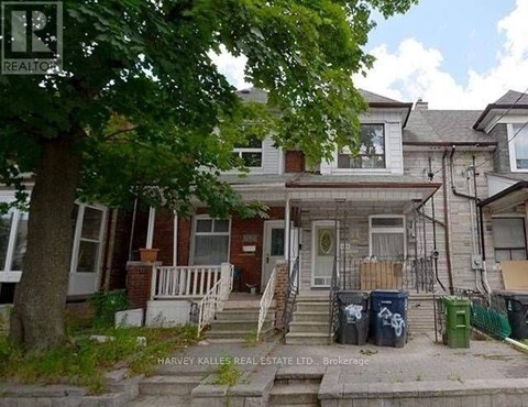 A house with a tree in front of it.