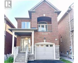 A brick house with a white garage door and a balcony.