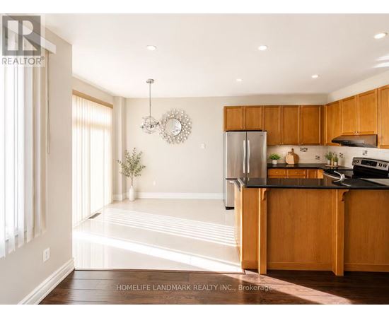 A kitchen with wooden cabinets and a black countertop.