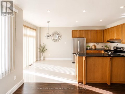 A kitchen with wooden cabinets and a black countertop.