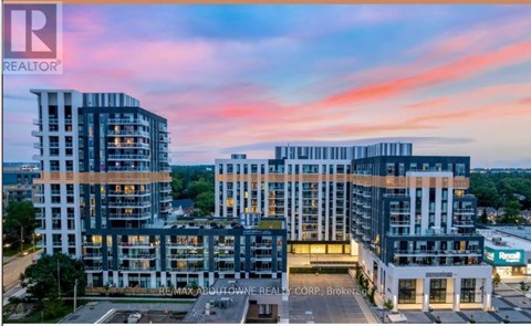 A modern multi-story building complex with the RE/MAX Aboutown Realty Corp. Brokerage sign in front.
