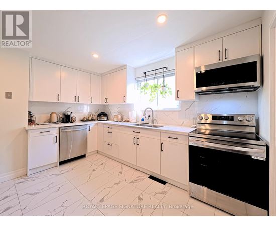 A kitchen with white cabinets and appliances.