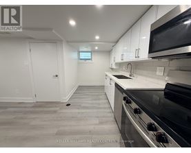 A kitchen with a stove top oven and microwave above it.