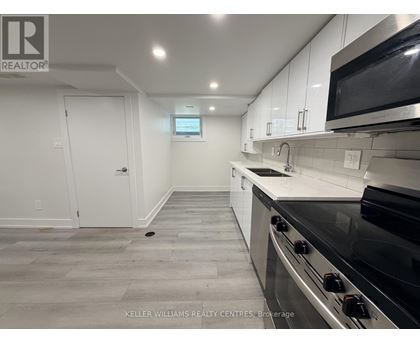 A kitchen with a stove top oven and microwave above it.