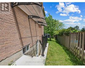 A brick building with a wooden fence in the yard.
