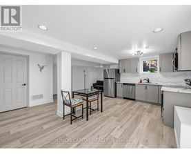 A kitchen with a table and chairs in the middle of the room.