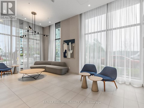 A living room with a grey sofa, a blue chair and a wooden table.