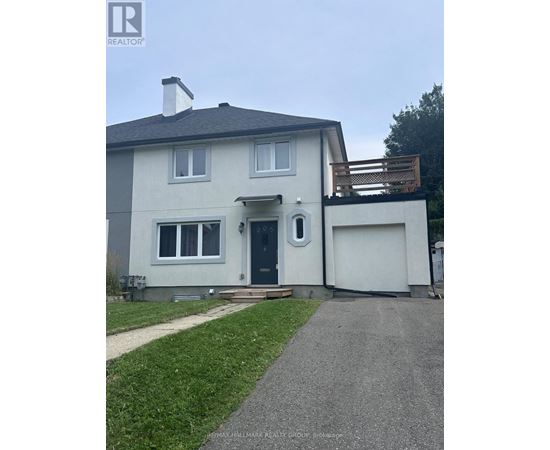 A house with a grey roof and a white garage door.