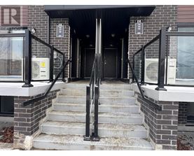 A set of stairs leading to a black door with a glass window above it.
