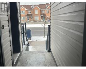 A view from a doorway looking out to a residential street.