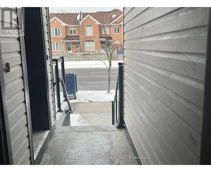 A view from a doorway looking out to a residential street.