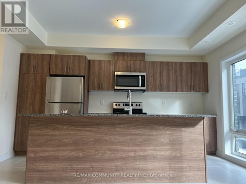 A kitchen with brown cabinets and a wooden counter.