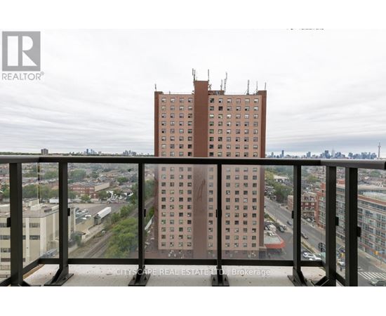 A tall building is seen from a balcony.