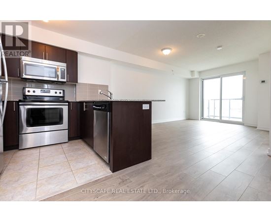 A modern kitchen with dark brown cabinets and stainless steel appliances.