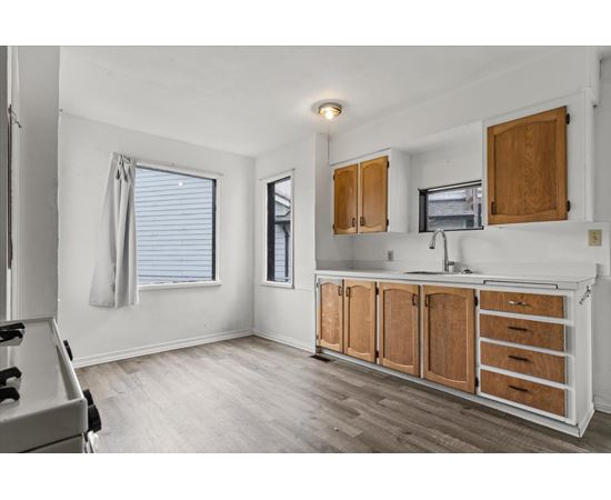 A kitchen with wooden cabinets and a white countertop.