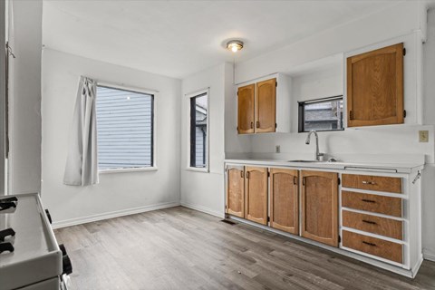 A kitchen with wooden cabinets and a white countertop.
