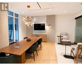 A modern dining room with a wooden table and chairs.