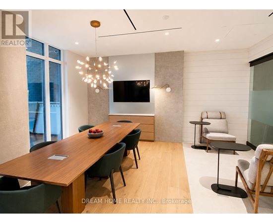 A modern dining room with a wooden table and chairs.