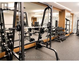 A gym with a row of weightlifting machines.