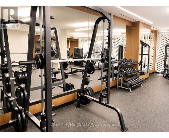 A gym with a row of weightlifting machines.