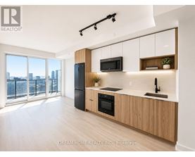 A modern kitchen with wooden cabinets and a view of the city.