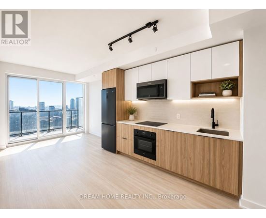 A modern kitchen with wooden cabinets and a view of the city.