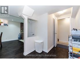A white toilet sits in a small, empty room.
