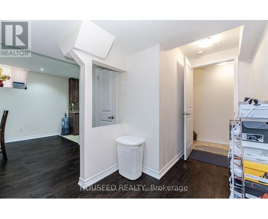 A white toilet sits in a small, empty room.