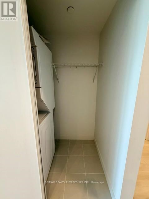 A small, empty kitchen with a white refrigerator and a white cabinet.