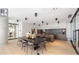 A modern dining room with a large table and chairs.