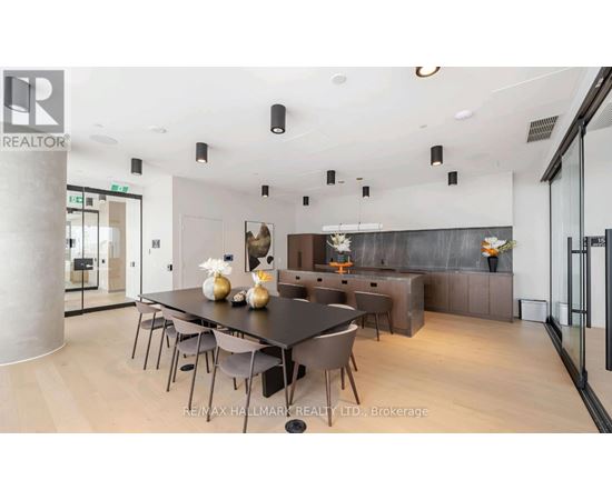 A modern dining room with a large table and chairs.
