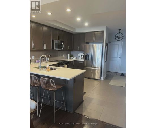 A kitchen with a white counter top and brown cabinets.