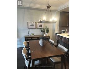 A dining room with a wooden table and chairs.