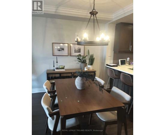 A dining room with a wooden table and chairs.