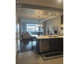 A modern kitchen with a dining area and a view of the backyard.
