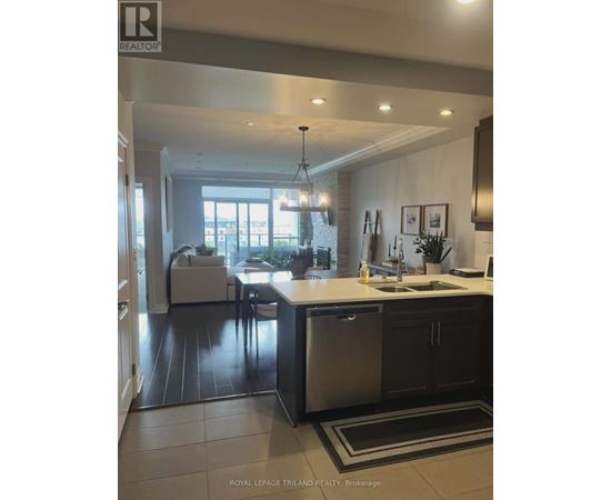 A modern kitchen with a dining area and a view of the backyard.