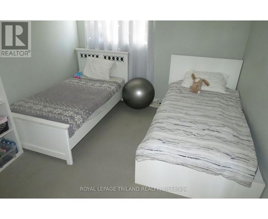 A bedroom with two beds and a ball.