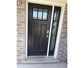 A black door with a glass window and a handle.
