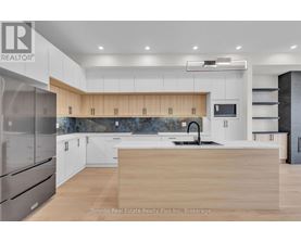 A modern kitchen with wooden countertops and stainless steel appliances.