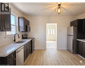 A kitchen with a sink, microwave, and refrigerator.