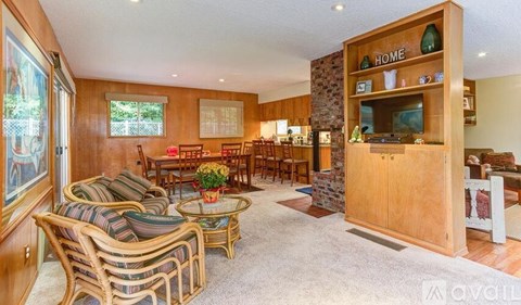 A living room with a sofa set, a coffee table, and a TV.