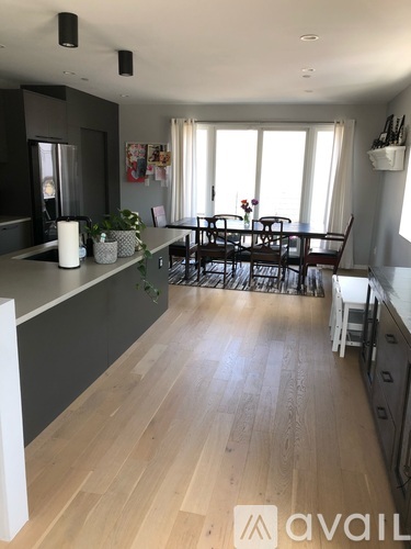 A kitchen with a dining table and chairs.