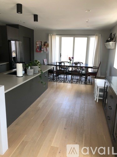 A kitchen with a dining table and chairs.