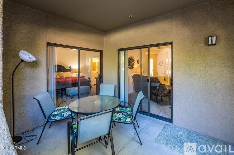 A living room with a glass table and chairs.